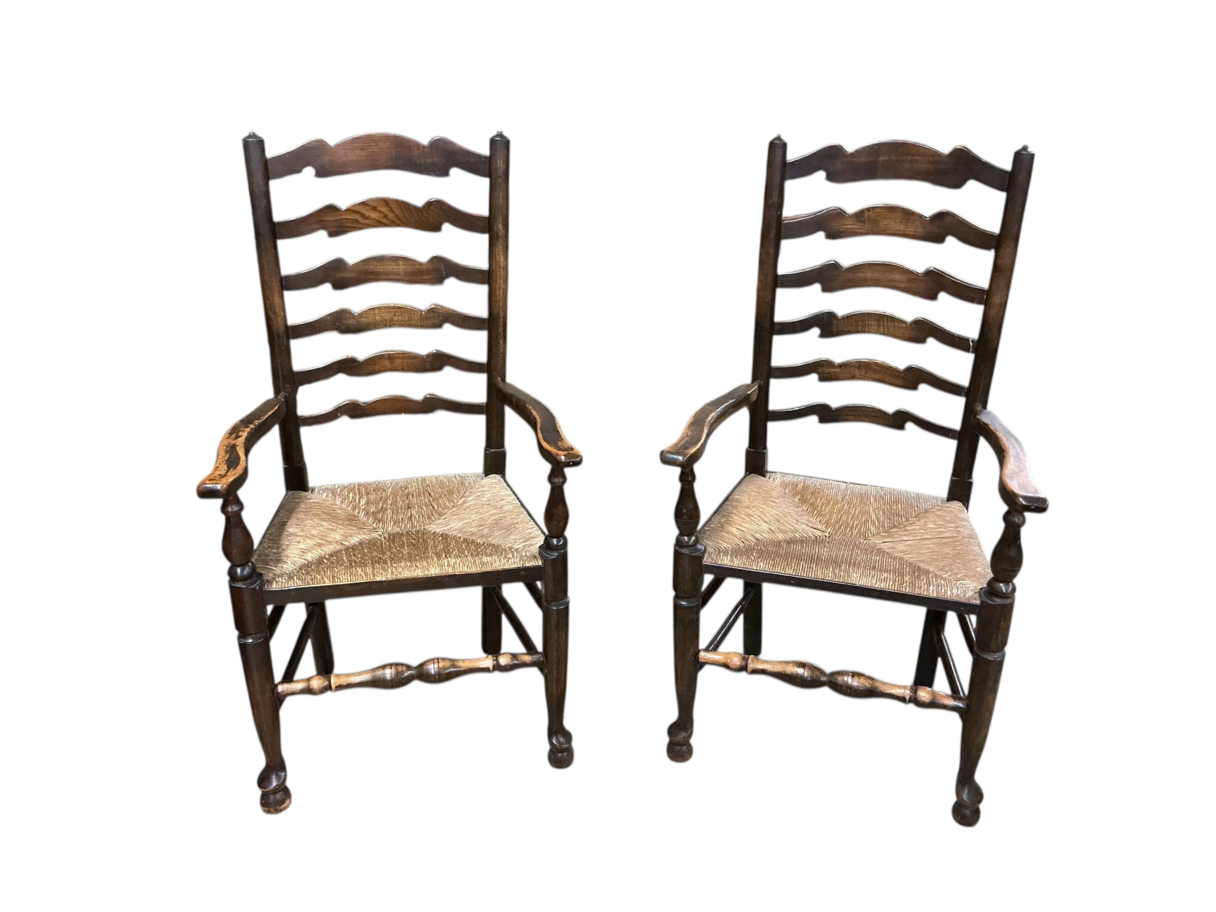 A set of six Lancashire style elm and beech rush seat ladderback dining chairs, two with arms
